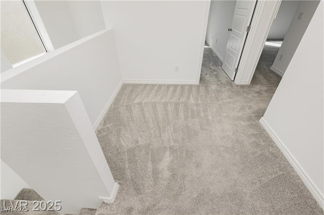 unfurnished room with baseboards and carpet