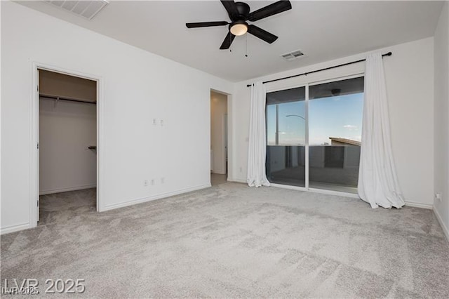 unfurnished bedroom with access to outside, baseboards, visible vents, and carpet