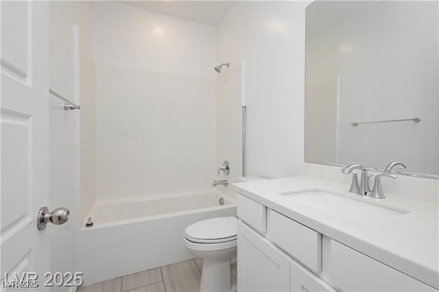 bathroom with vanity, bathtub / shower combination, and toilet