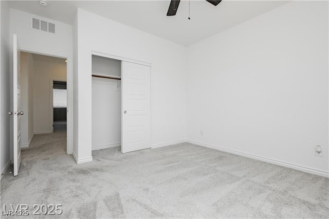 unfurnished bedroom featuring carpet floors, a ceiling fan, baseboards, visible vents, and a closet