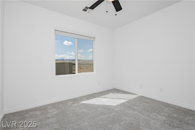 carpeted empty room featuring baseboards, ceiling fan, and visible vents