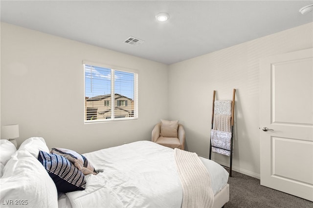 carpeted bedroom featuring baseboards and visible vents