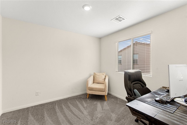 office space featuring carpet floors, baseboards, and visible vents