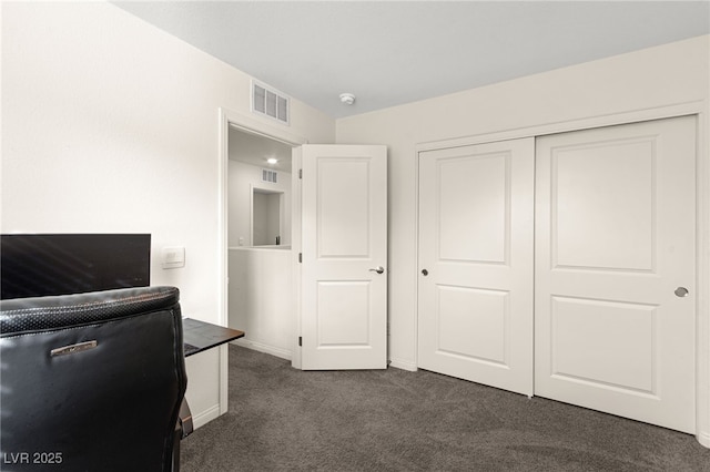 bedroom featuring baseboards, a closet, dark carpet, and visible vents