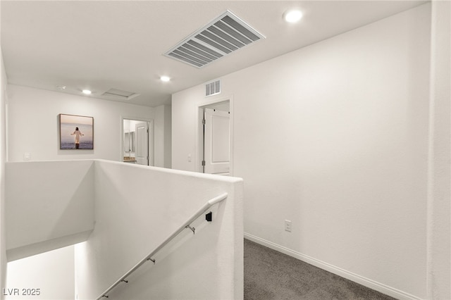 hall featuring recessed lighting, baseboards, visible vents, and an upstairs landing