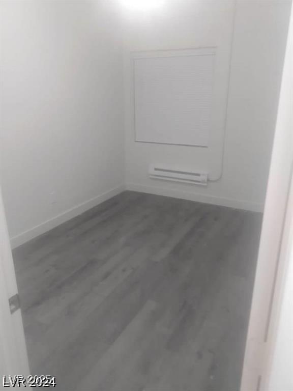 1317 Exley Ave, Las Vegas, NV 89104 - empty room featuring baseboards, wood finished floors, and baseboard heating