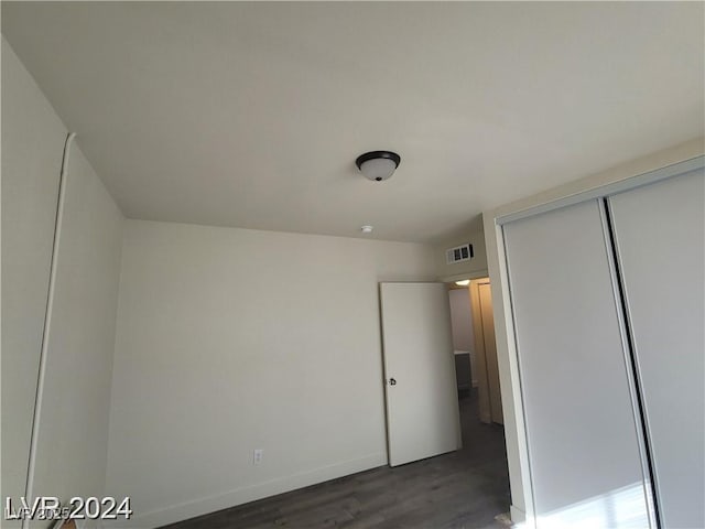 1317 Exley Ave, Las Vegas, NV 89104 - unfurnished bedroom featuring baseboards, visible vents, wood finished floors, and a closet
