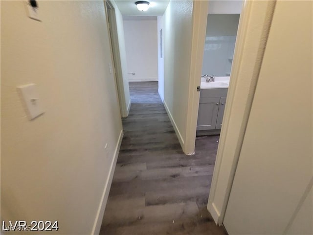 1317 Exley Ave, Las Vegas, NV 89104 - hall featuring dark wood-style flooring and baseboards