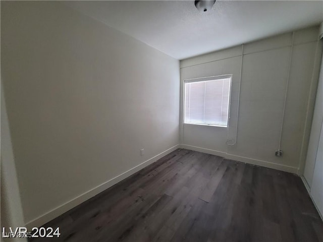1317 Exley Ave, Las Vegas, NV 89104 - empty room featuring baseboards and dark wood-style flooring