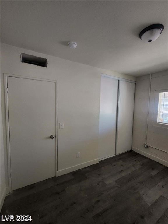 1317 Exley Ave, Las Vegas, NV 89104 - unfurnished room with baseboards and dark wood-type flooring
