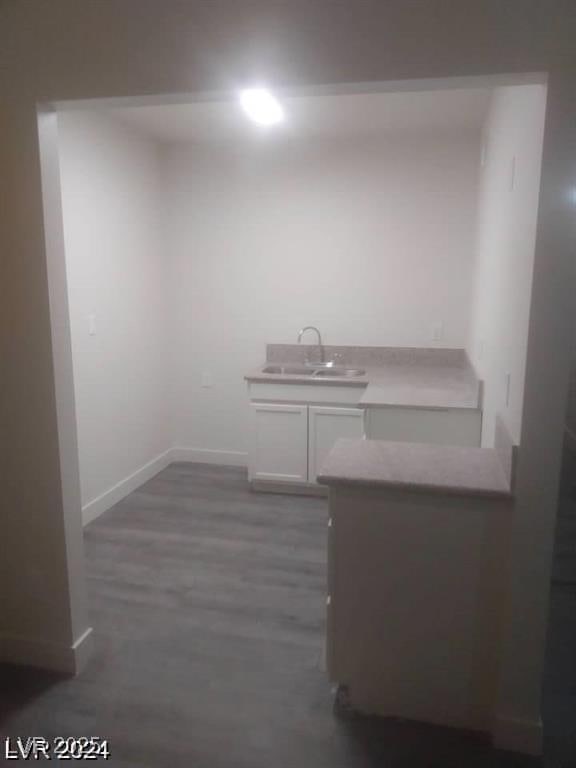 1317 Exley Ave, Las Vegas, NV 89104 - interior space with baseboards, a sink, and wood finished floors