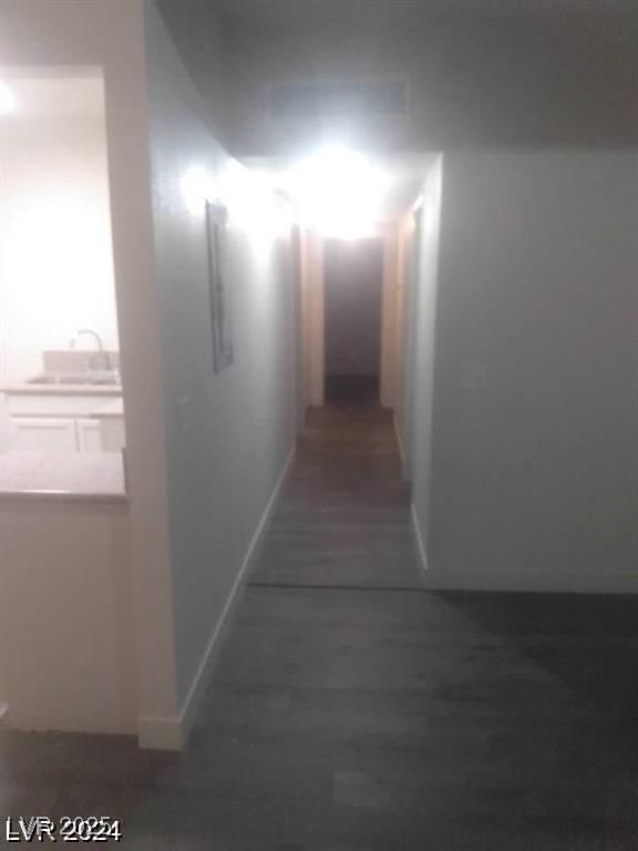 1317 Exley Ave, Las Vegas, NV 89104 - corridor featuring a sink, baseboards, and wood finished floors