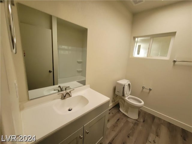 1317 Exley Ave, Las Vegas, NV 89104 - full bathroom with vanity, baseboards, wood finished floors, and toilet