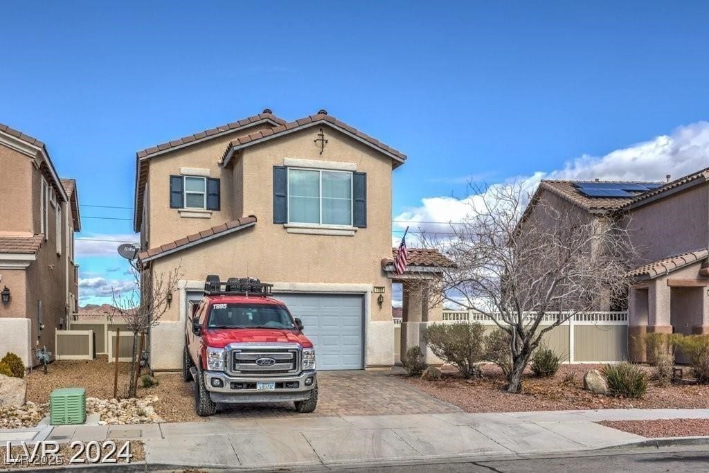 1168 Aspen Cliff Dr, Henderson, NV 89011 - traditional-style home with fence, a tile roof, a garage, stucco siding, and decorative driveway