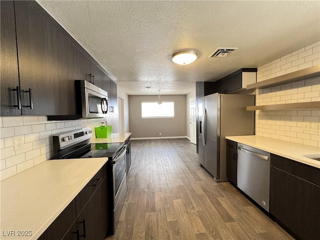 kitchen featuring visible vents, light countertops, a textured ceiling, and appliances with stainless steel finishes