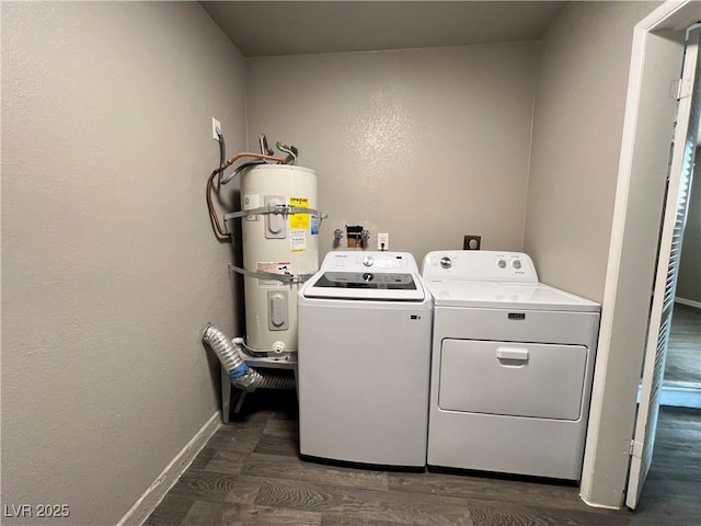 clothes washing area with laundry area, baseboards, dark wood-style floors, washer and clothes dryer, and water heater