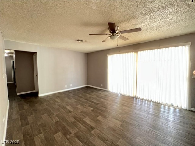 unfurnished room featuring a textured ceiling, ceiling fan, visible vents, and dark wood-type flooring