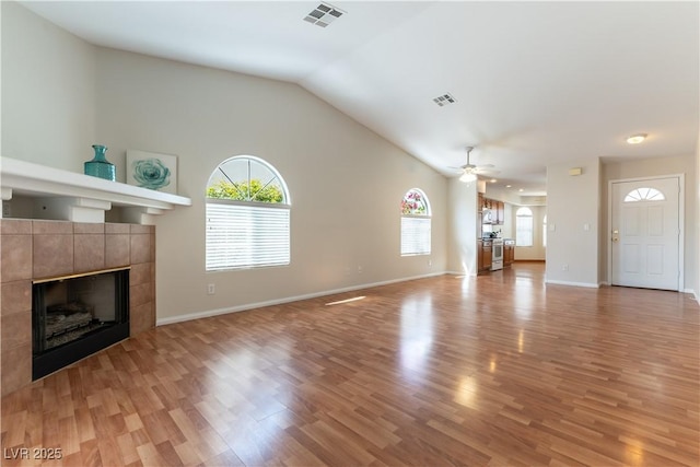 3510 Judah Way, Las Vegas, NV 89147 - unfurnished living room with visible vents, light wood finished floors, ceiling fan, and a tile fireplace