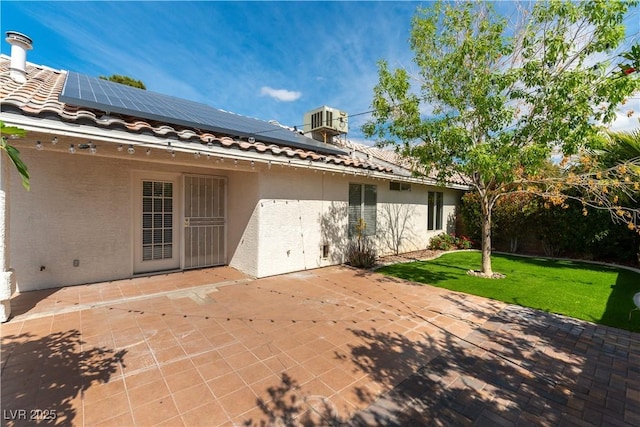 3510 Judah Way, Las Vegas, NV 89147 - rear view of house featuring a lawn, stucco siding, a tiled roof, and solar panels