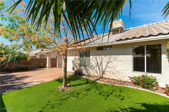 3510 Judah Way, Las Vegas, NV 89147 - view of side of home featuring a patio area, central air condition unit, fence, a yard, and stucco siding