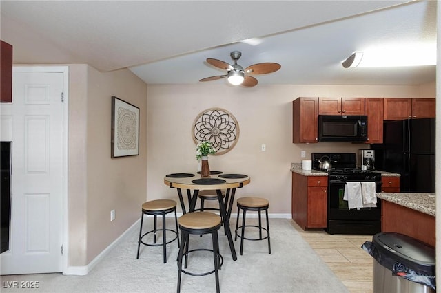2120 Ramrod Ave Unit 513, Henderson, NV 89014 - kitchen featuring black appliances, a ceiling fan, baseboards, and light stone counters