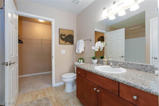 2120 Ramrod Ave Unit 513, Henderson, NV 89014 - full bath with vanity, toilet, a spacious closet, baseboards, and wood finished floors