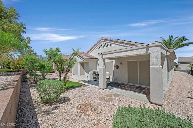 1991 High Mesa Dr, Henderson, NV 89012 - view of front of home featuring stucco siding, a patio area, and a tiled roof