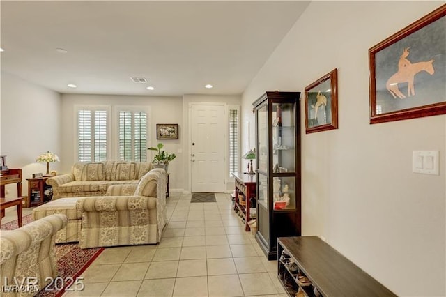 living room featuring light tile patterned floors, baseboards, recessed lighting, and visible vents