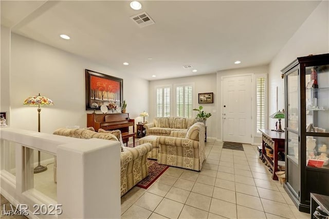 living room featuring visible vents, recessed lighting, and light tile patterned floors