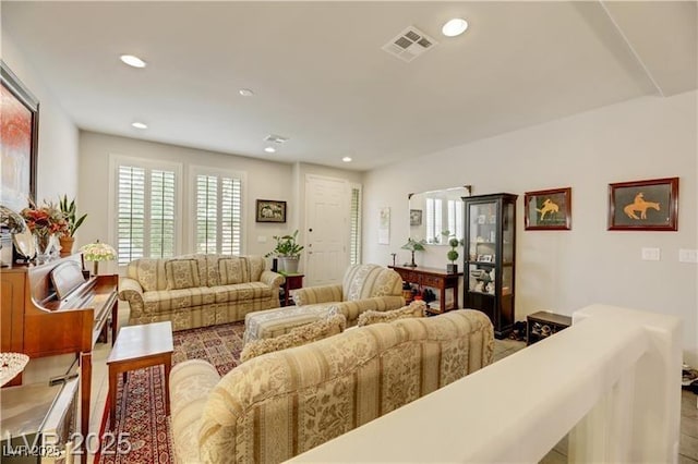 living area with visible vents and recessed lighting