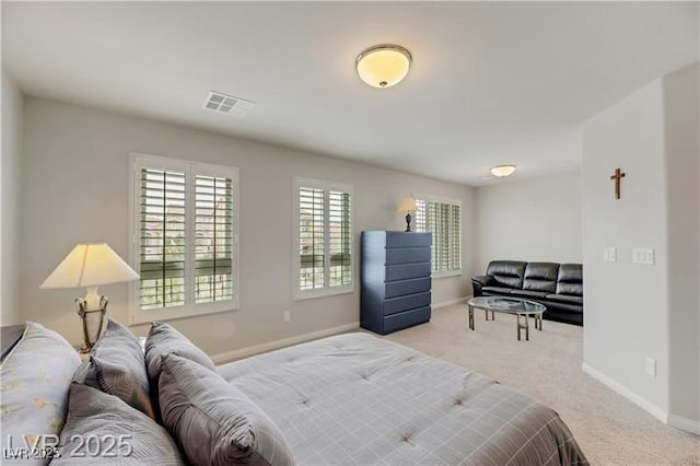carpeted bedroom featuring baseboards and visible vents