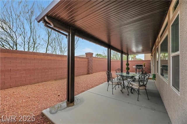 view of patio with outdoor dining area and a fenced backyard