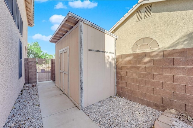 204 Appian Way, Henderson, NV 89002 - view of property exterior featuring an outdoor structure, a gate, a shed, and fence