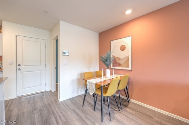 dining area featuring baseboards, recessed lighting, and wood finished floors