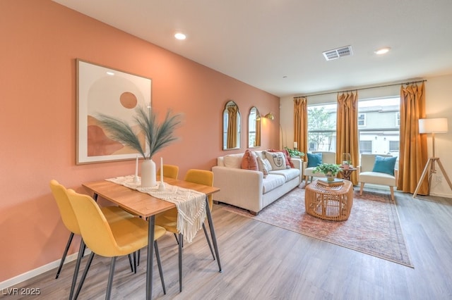 living area with visible vents, recessed lighting, light wood finished floors, and baseboards