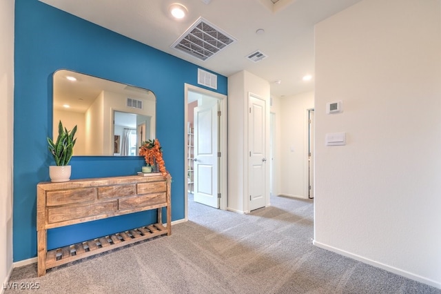 interior space with carpet flooring and visible vents