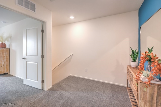 empty room featuring carpet floors, baseboards, recessed lighting, and visible vents