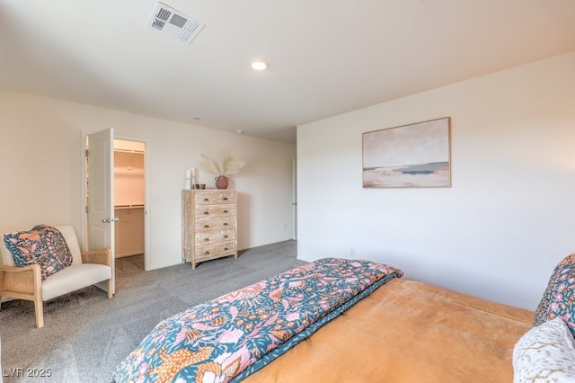carpeted bedroom with a walk in closet, a closet, recessed lighting, and visible vents