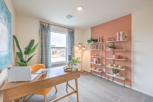 carpeted office space with baseboards and visible vents