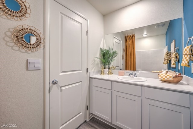 bathroom featuring vanity and wood finished floors