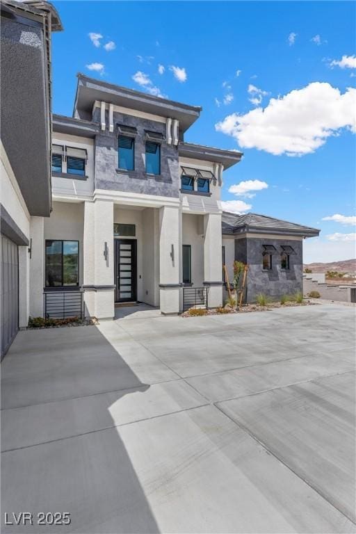 prairie-style home featuring stucco siding
