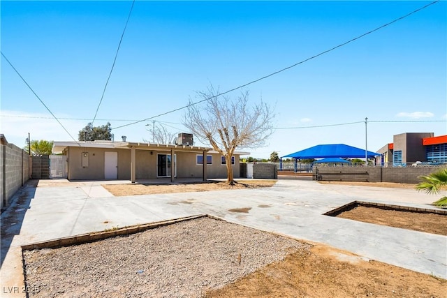 1020 Baker Ave, Las Vegas, NV 89108 - back of property with a fenced backyard, a patio area, and stucco siding