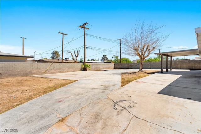 1020 Baker Ave, Las Vegas, NV 89108 - view of yard featuring a fenced backyard, a patio, and concrete driveway
