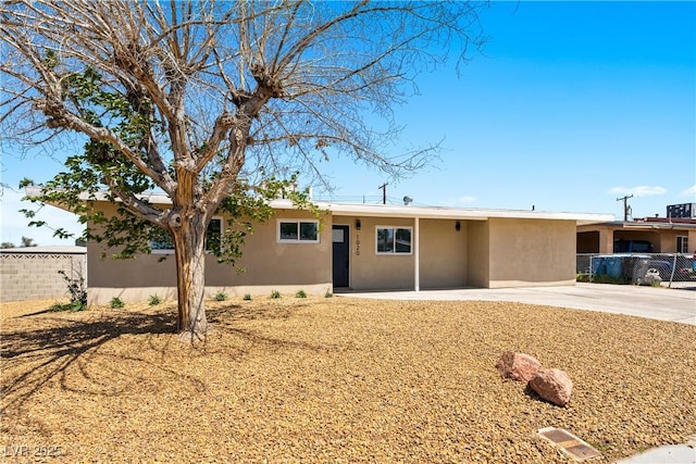 1020 Baker Ave, Las Vegas, NV 89108 - ranch-style house with stucco siding, driveway, and fence