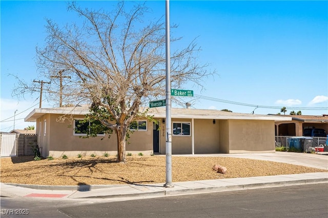 1020 Baker Ave, Las Vegas, NV 89108 - ranch-style house with stucco siding, driveway, and fence