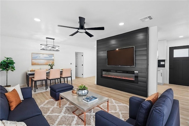 1020 Baker Ave, Las Vegas, NV 89108 - living area featuring ceiling fan, visible vents, a large fireplace, light wood-type flooring, and recessed lighting