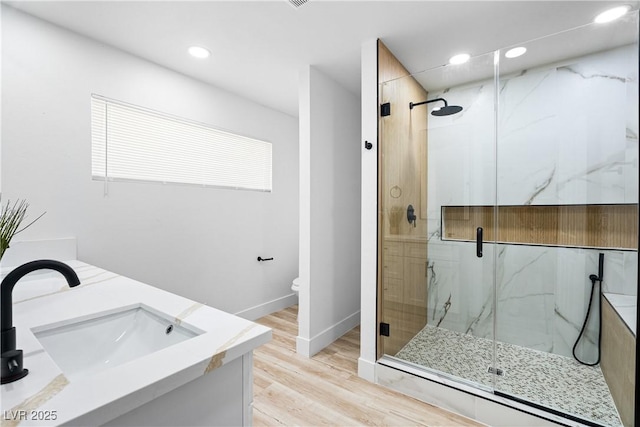 1020 Baker Ave, Las Vegas, NV 89108 - full bath featuring recessed lighting, a marble finish shower, a sink, and wood finished floors