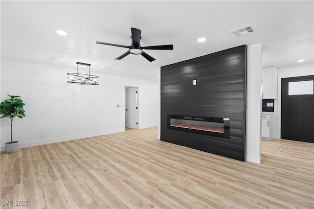 1020 Baker Ave, Las Vegas, NV 89108 - unfurnished living room featuring a large fireplace, recessed lighting, light wood-style flooring, and visible vents