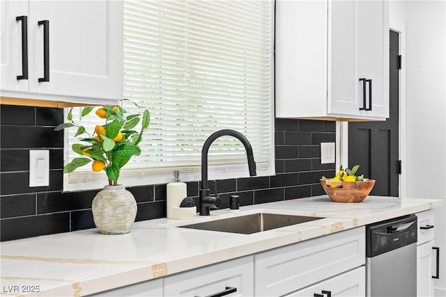 1020 Baker Ave, Las Vegas, NV 89108 - kitchen with white cabinetry, decorative backsplash, a sink, and dishwasher