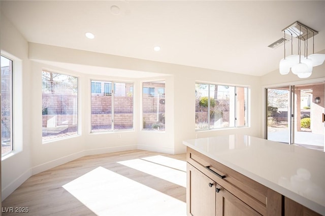 interior space featuring visible vents, baseboards, recessed lighting, light wood-style flooring, and vaulted ceiling